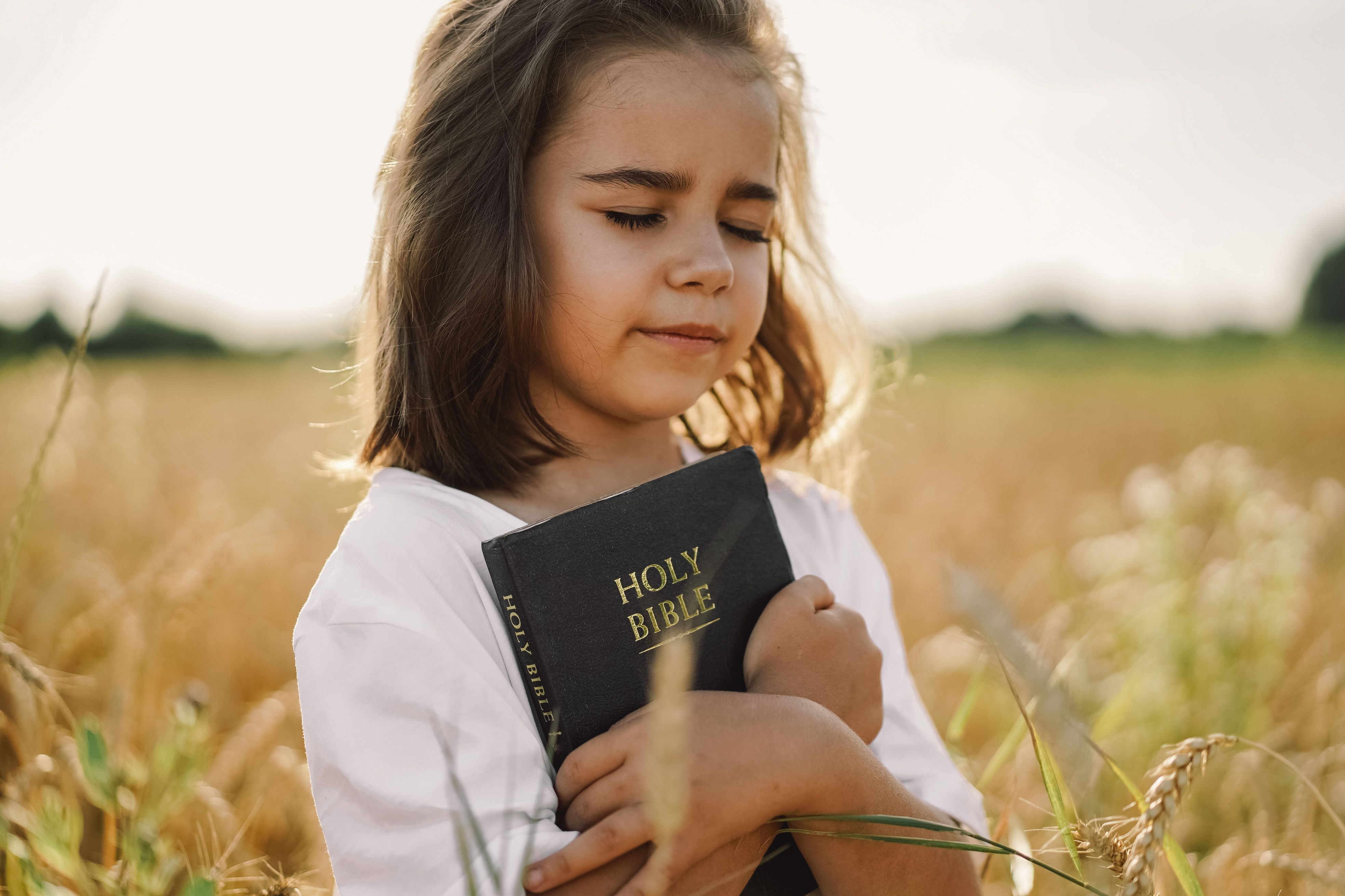 girl-holds-bible-2023-11-27-05-10-36-utc.jpg